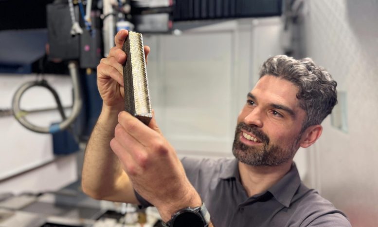 Ryan Brooke Inspects a Sample of the New Titanium