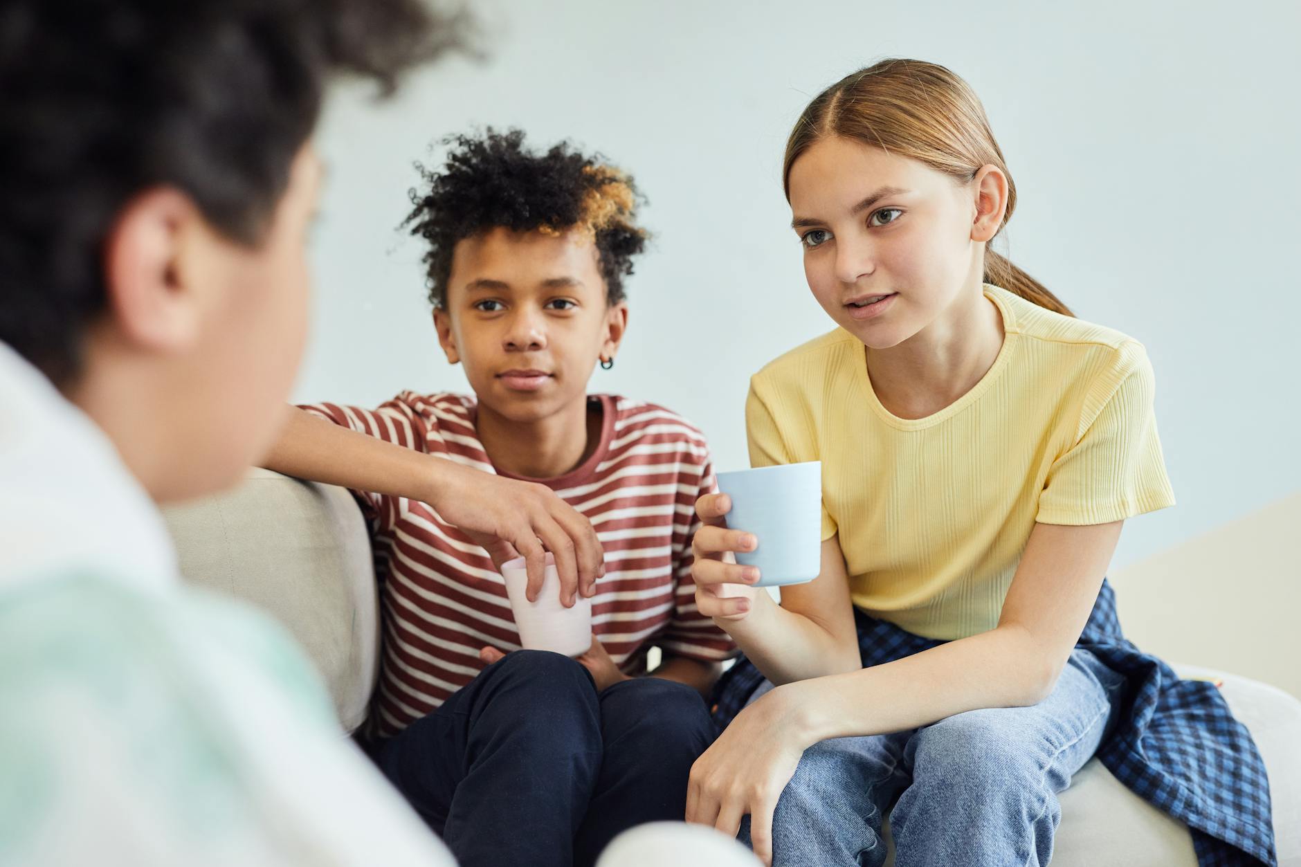 Group of diverse teenagers engaged in animated conversation, representing authentic social connection