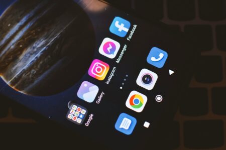 How Apple’s New App Store Changes Are Affecting Independent Developers Close-up view of smartphone screen showing various mobile app icons