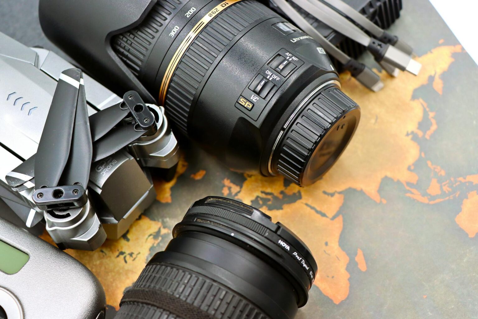 Professional drone and action camera equipment laid out for travel content creation