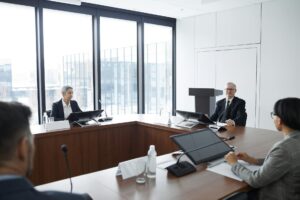 Professional business meeting with lawyers discussing documents around conference table