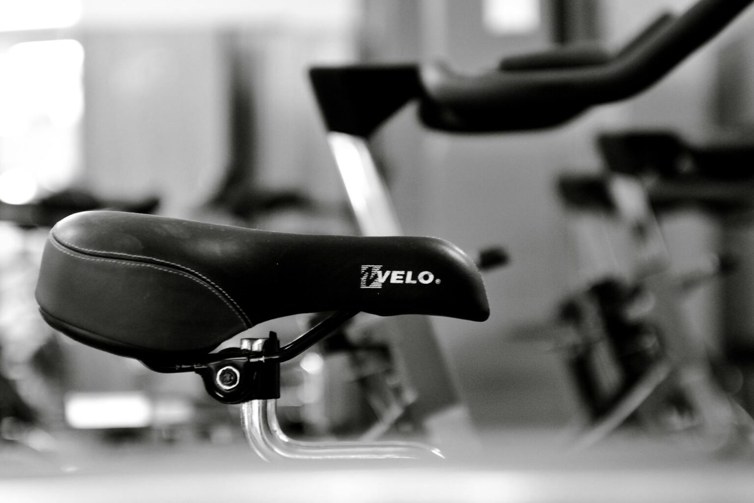 Modern stationary exercise bike with touchscreen display in home gym setting