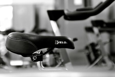 Modern stationary exercise bike with touchscreen display in home gym setting