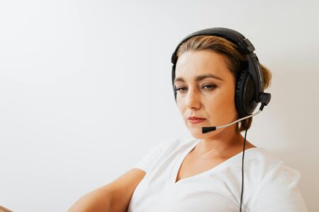 How OpenAI’s Latest ChatGPT Update Is Disrupting Customer Service Jobs Customer service representative wearing headset in modern call center environment