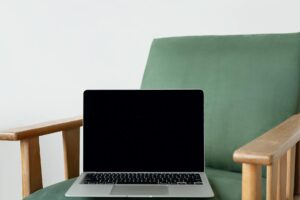 Designer working on laptop screen showing user interface design software