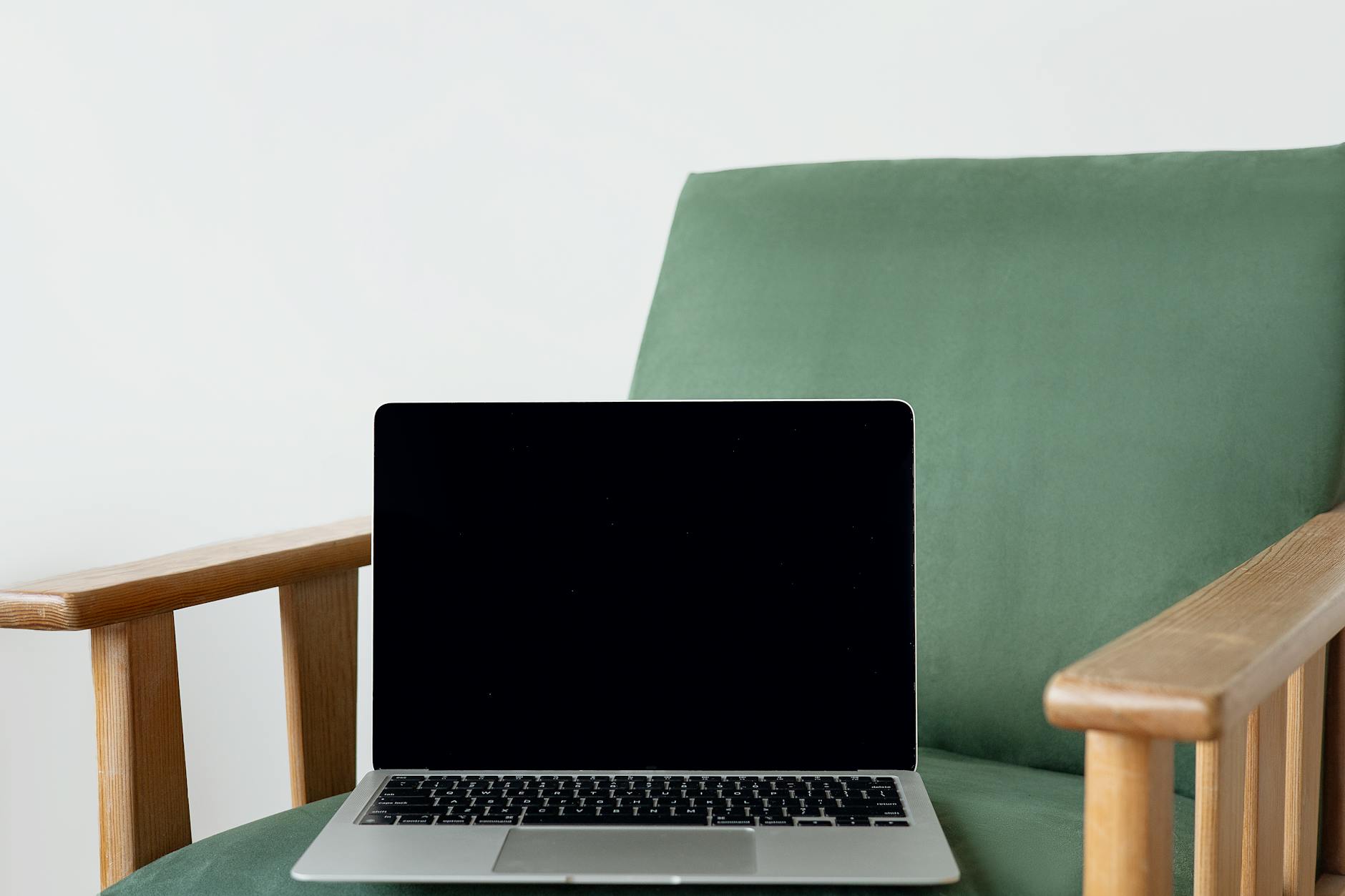 Designer working on laptop screen showing user interface design software