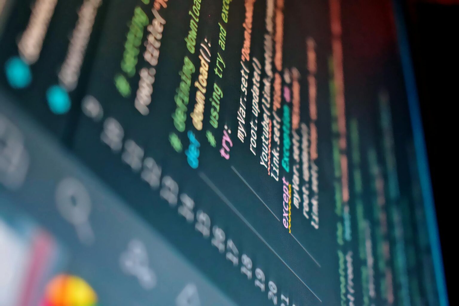 Developer working on code displayed on a computer monitor showing programming interface