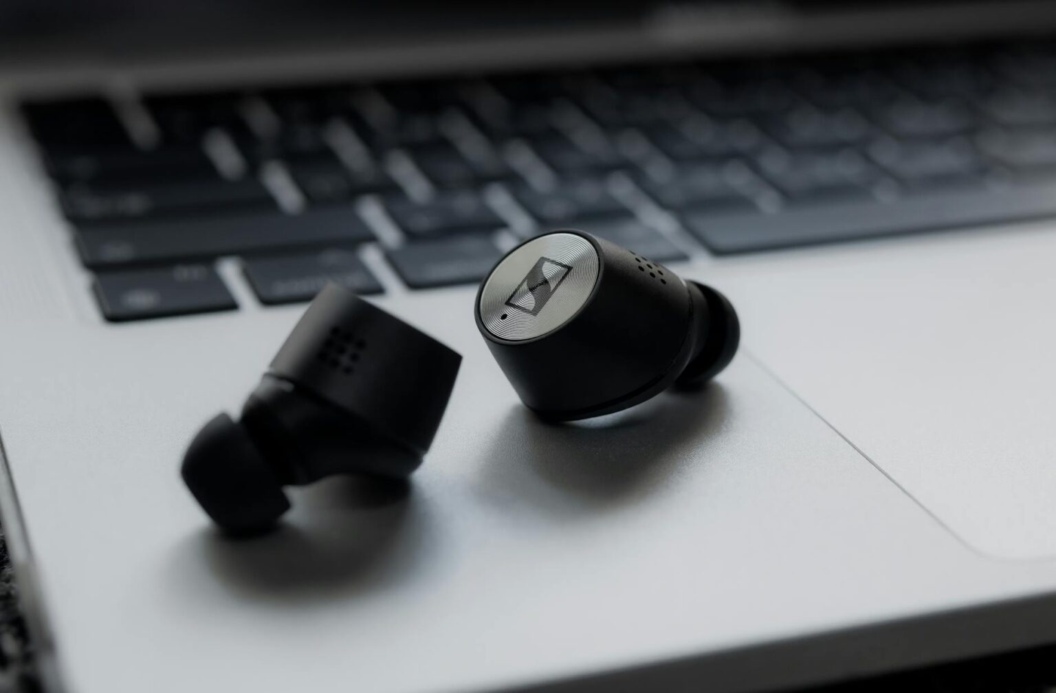Premium wireless earbuds on wooden surface showing sleek design