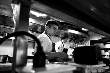 Professional restaurant kitchen with chefs working during busy service period