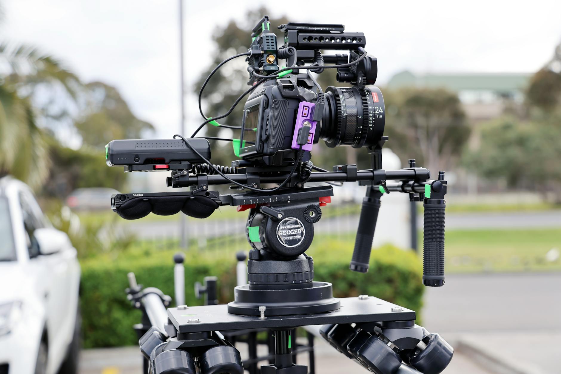 Professional video camera on tripod in filming setup with lighting equipment
