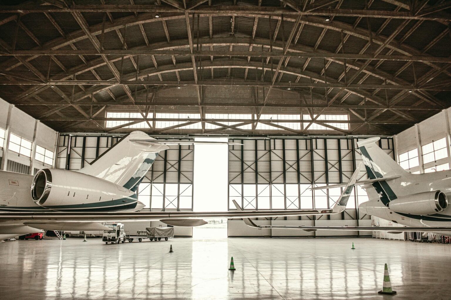 Aircraft maintenance technician working on airplane engine in hangar facility