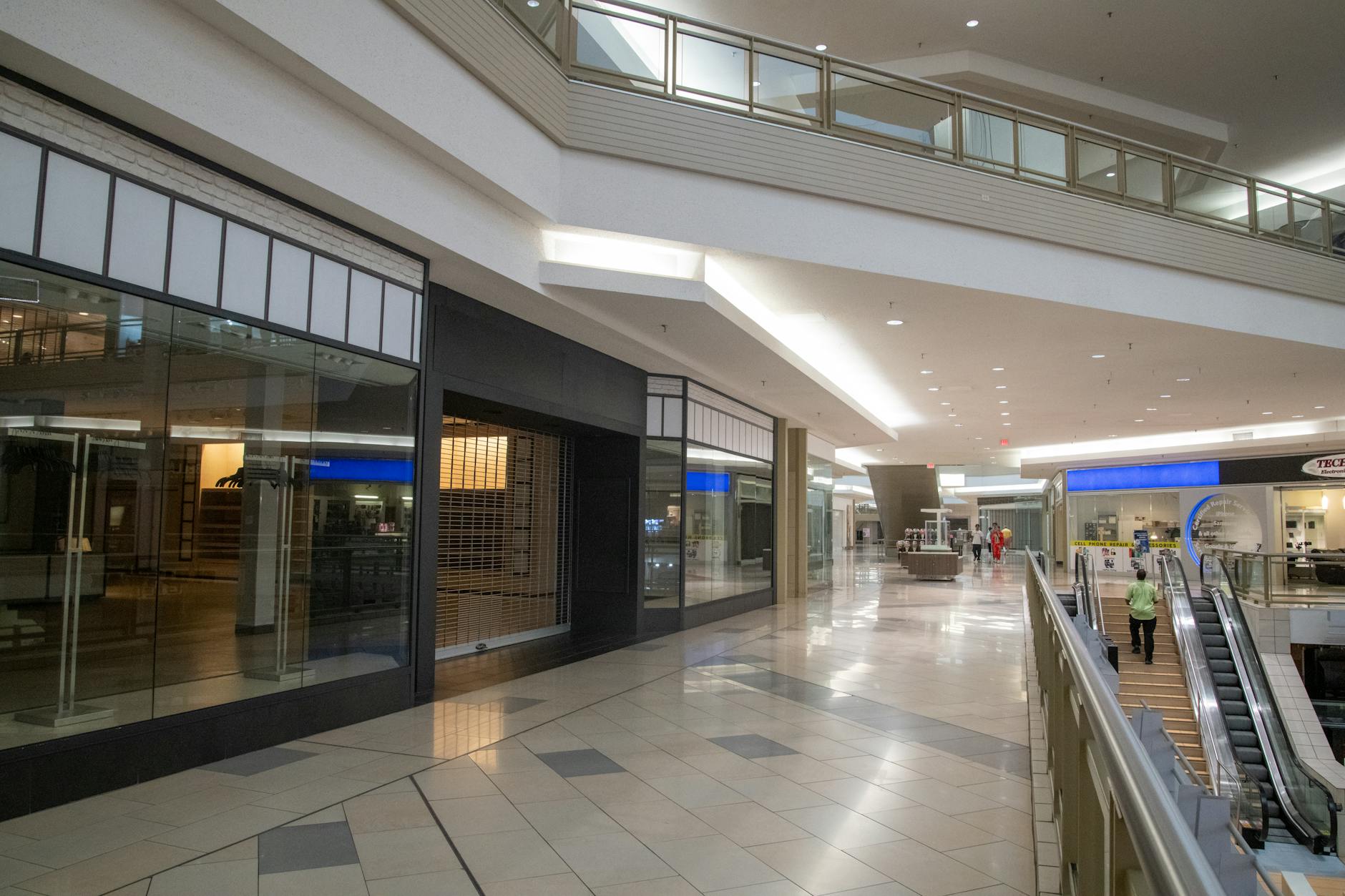 Empty shopping mall interior with vacant storefronts and walkways