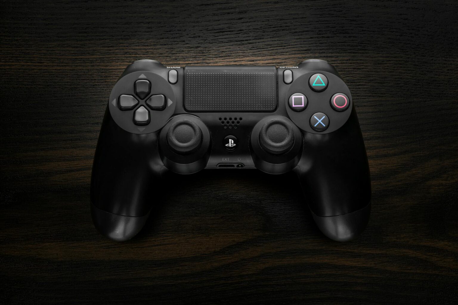 Modern gaming controller on dark surface representing portable gaming devices