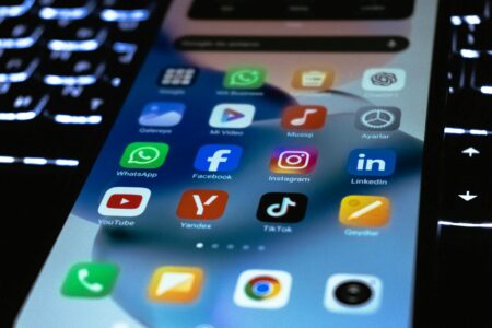 How Threads Is Finally Challenging Twitter’s News Dominance Among Journalists Person using smartphone displaying social media apps including Threads and other platforms