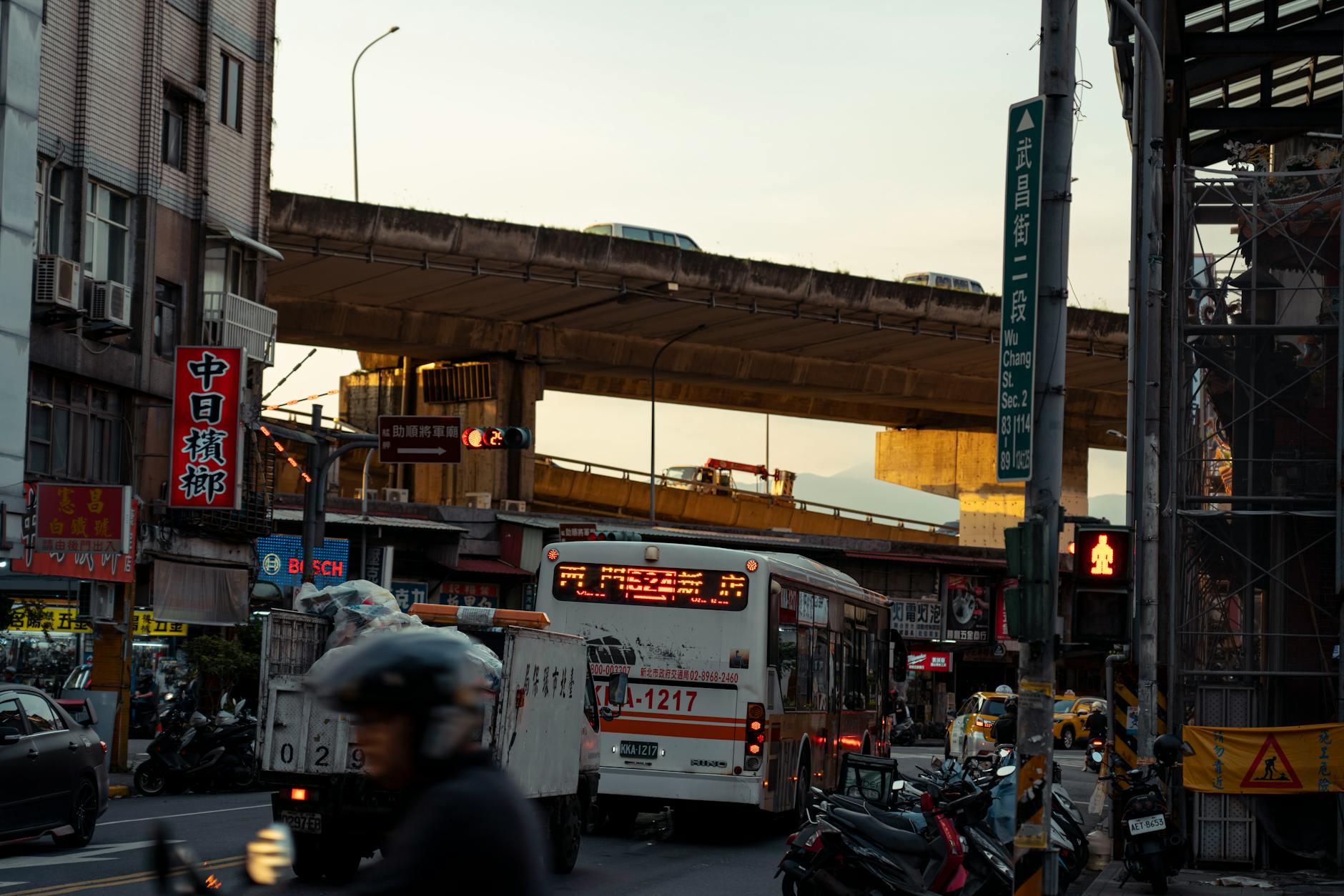 Aerial view of busy city intersection with multiple lanes of traffic and crosswalks