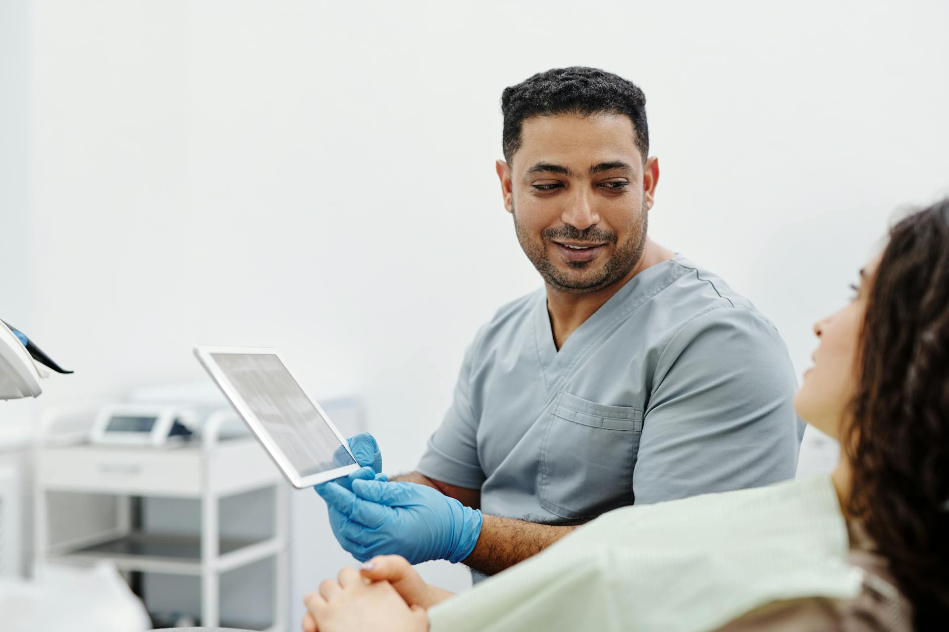 Medical professional using tablet device for patient care in clinical setting