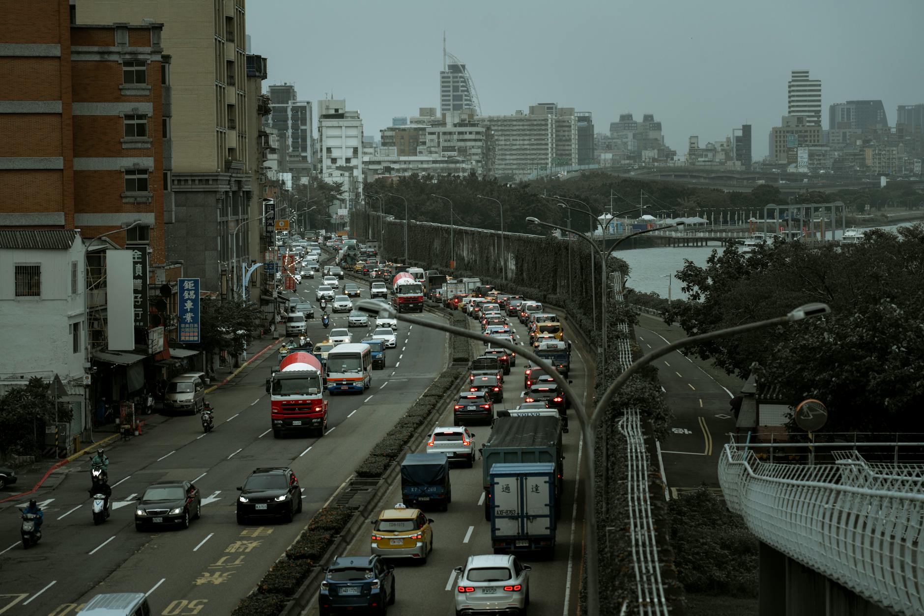 Urban traffic scene with motorcycles and cars in busy street