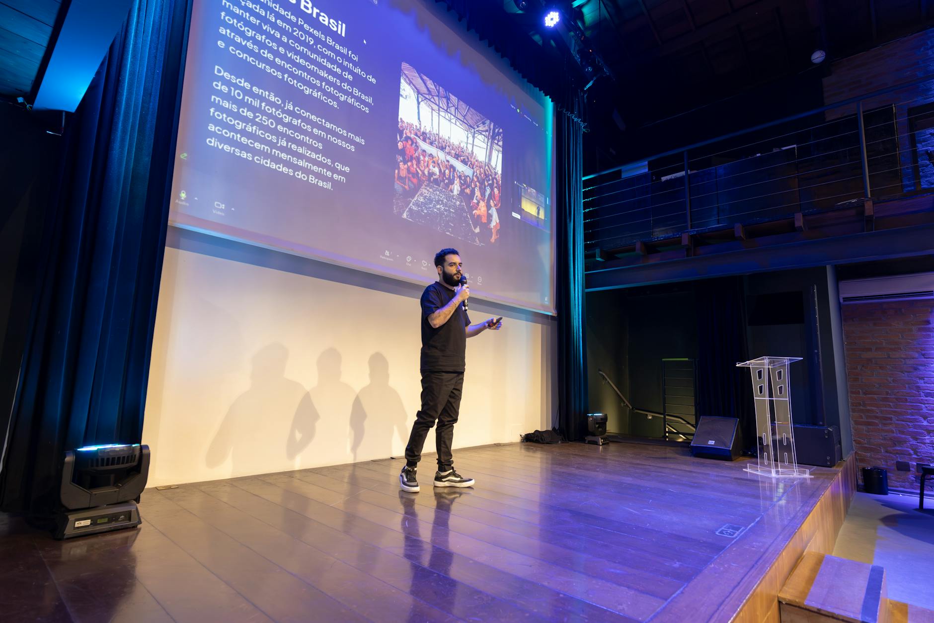 Professional speaking on stage at corporate event with audience