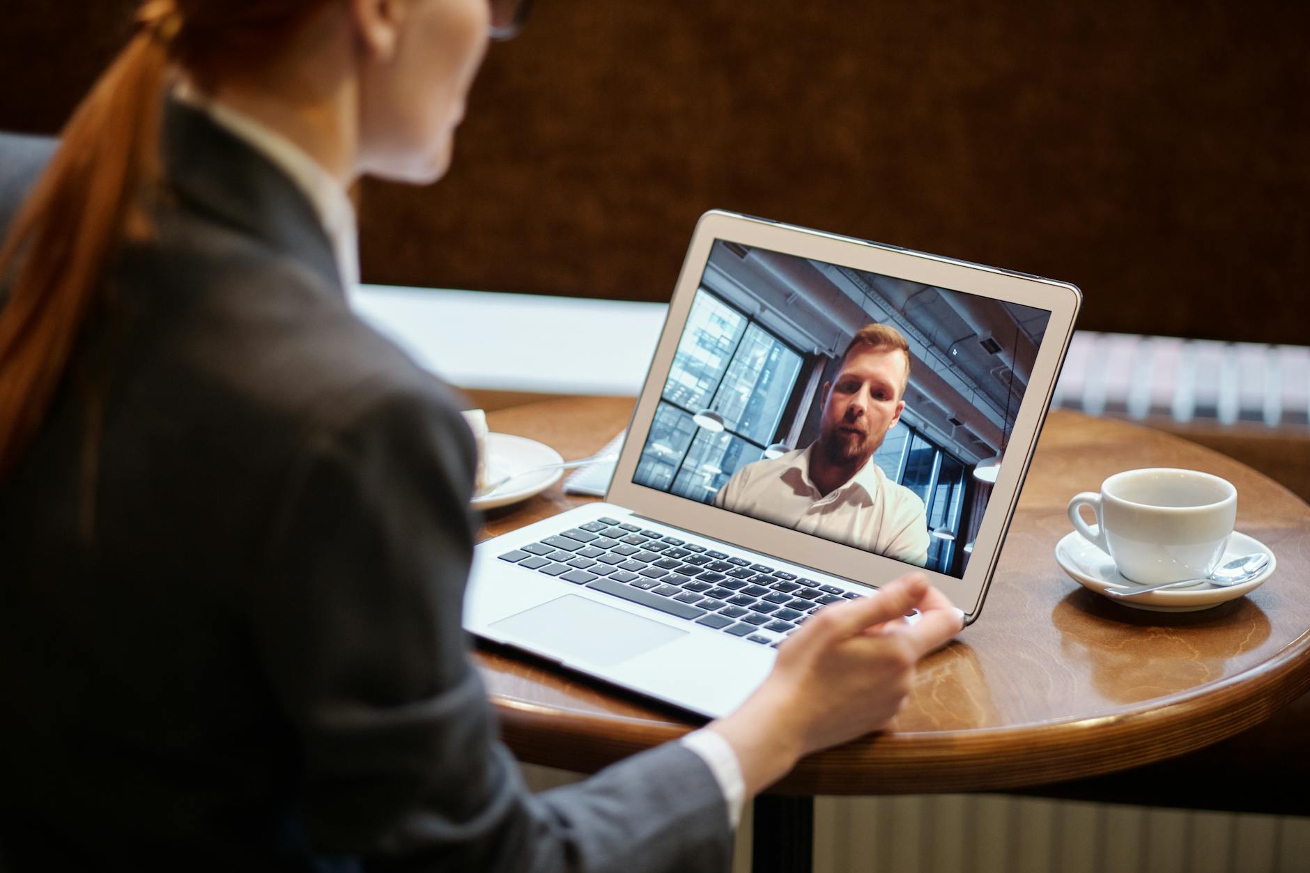 Person participating in a video conference call demonstrating remote work communication