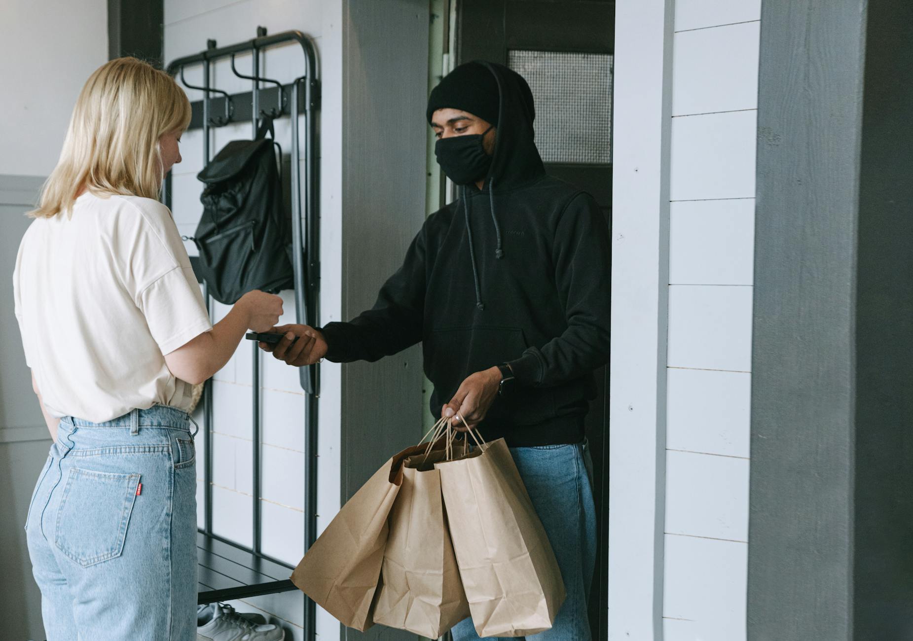 Package delivery at residential doorstep, showing the end result of voice-activated purchasing decisions