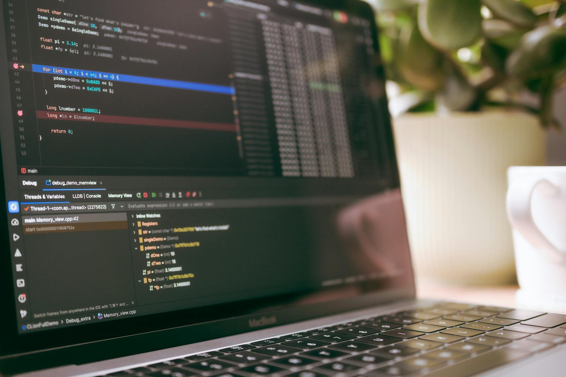 Clean workspace with laptop displaying code editor and development tools