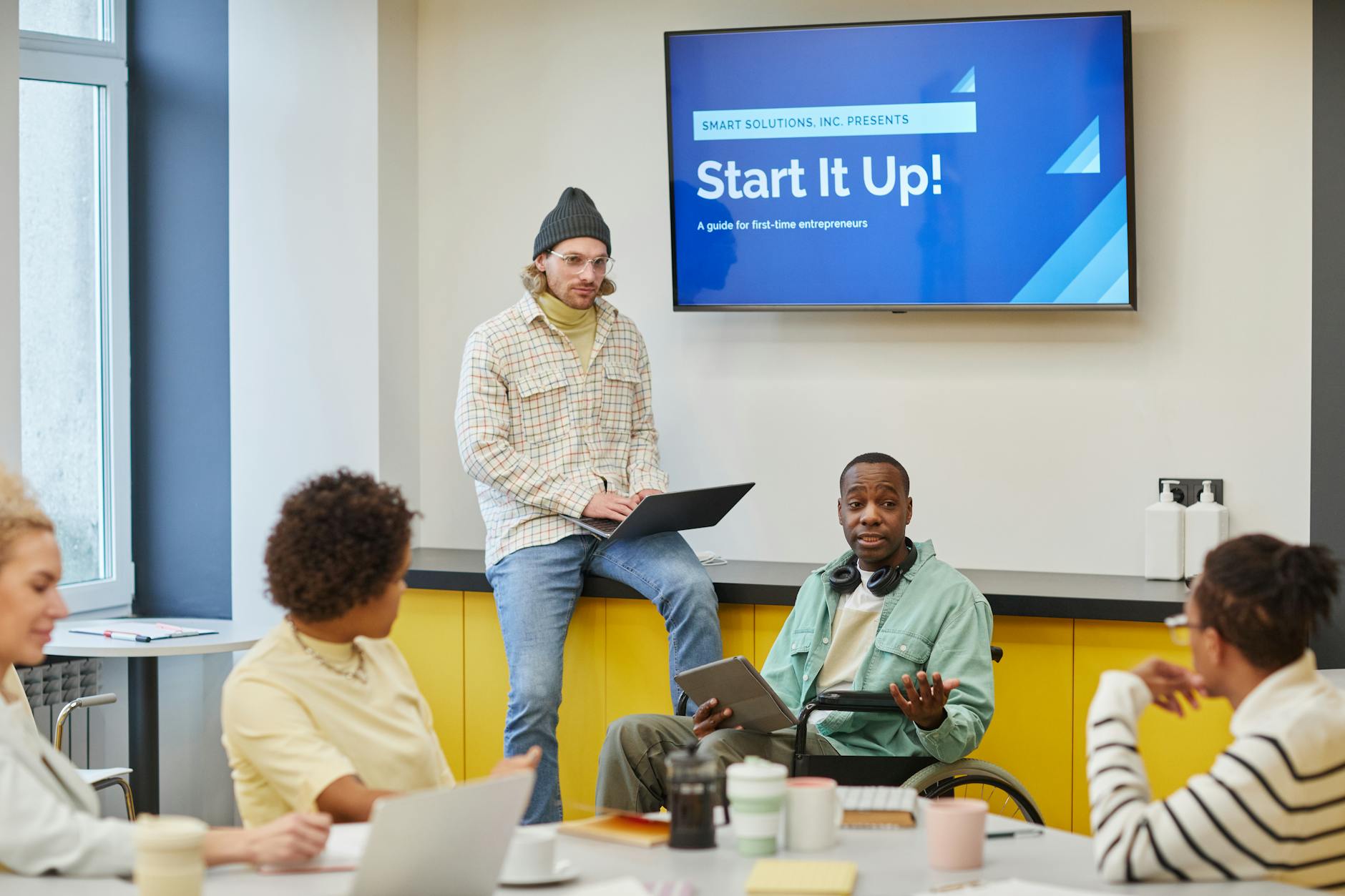 Business team collaborating around a conference table discussing technology solutions