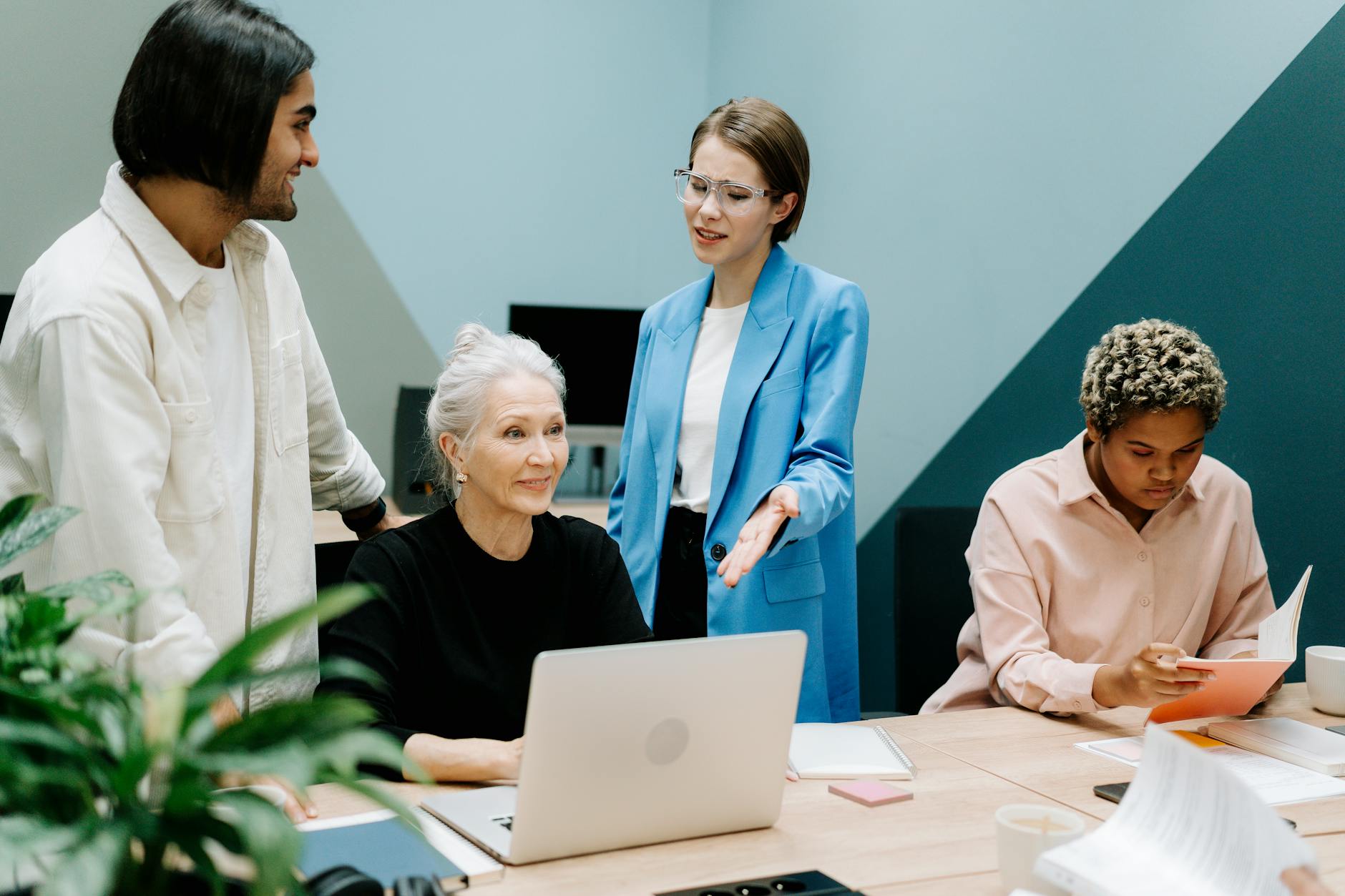 HR team reviewing employee data on laptops in a modern office setting