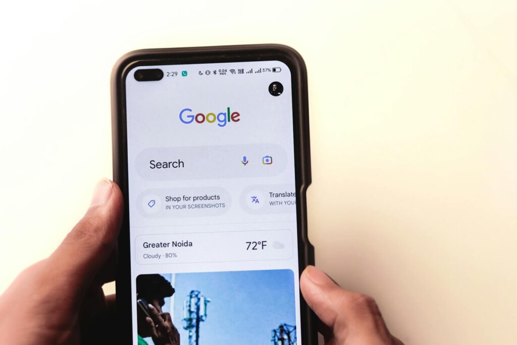 Glean’s Workplace Search Tool Is Threatening Microsoft Copilot’s Grip Employee using AI search tool on a laptop in a modern office environment