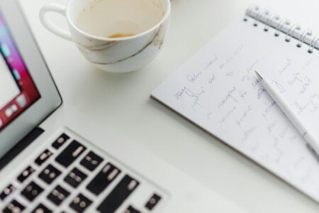 Substack’s Creator Exodus Is Accelerating as Newsletter Fatigue Sets In Person typing on laptop computer for newsletter writing and content creation
