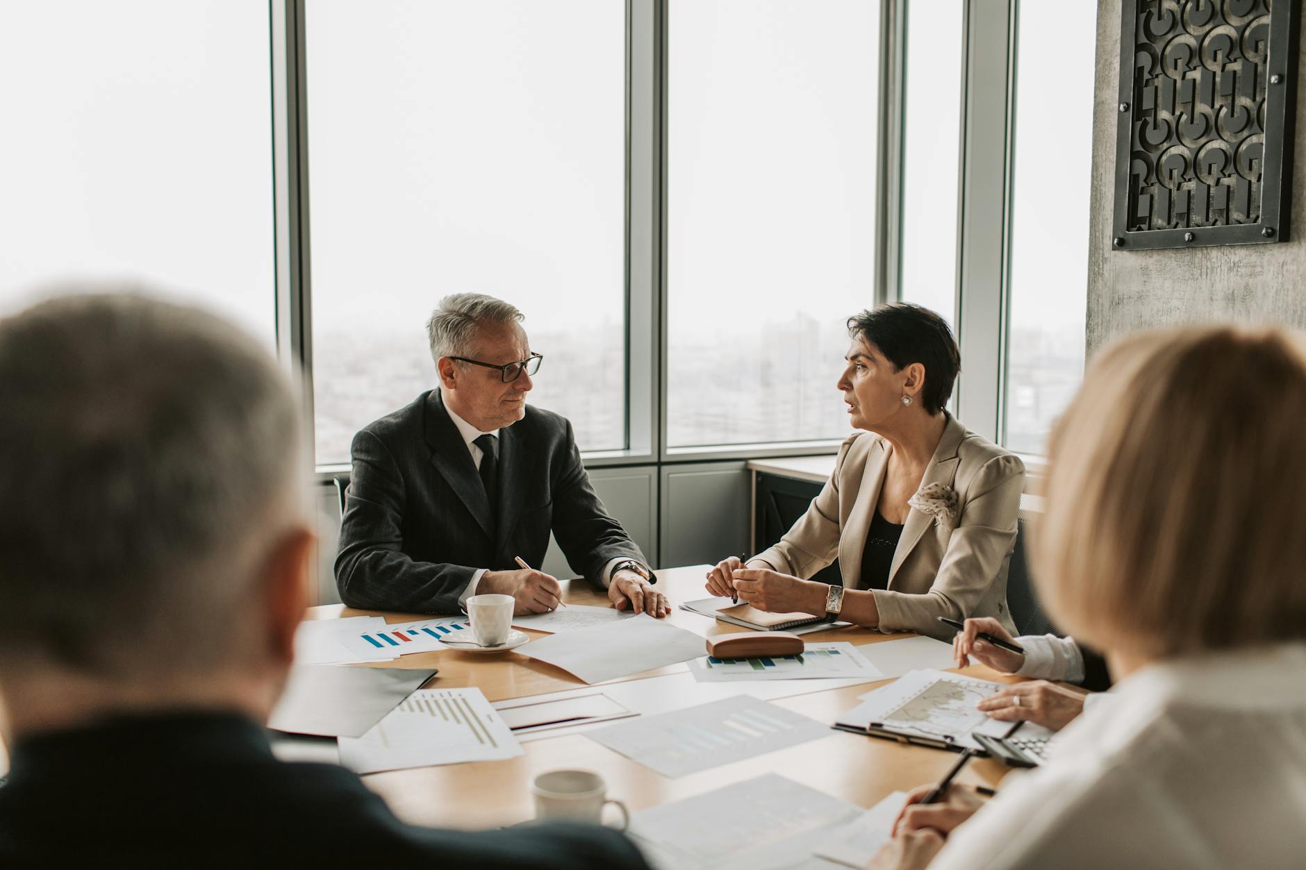Business professionals in a meeting room discussing investment strategy and startup concerns