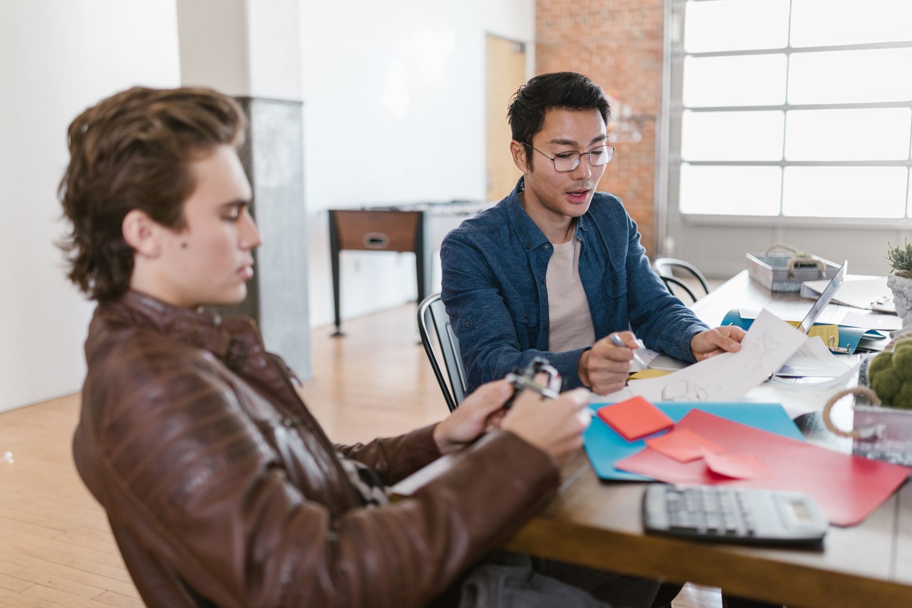 Early-stage startup team gathered around a table during a planning meeting