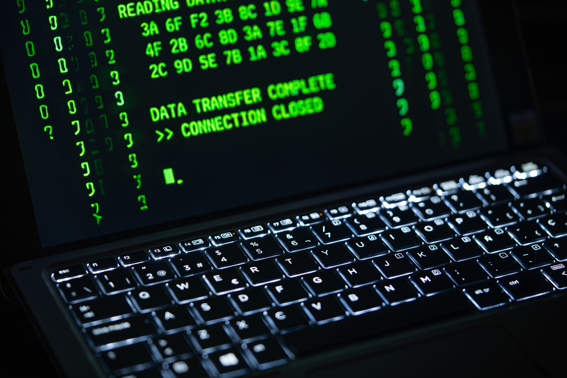 Person working on a laptop with security interface representing enterprise cybersecurity tools