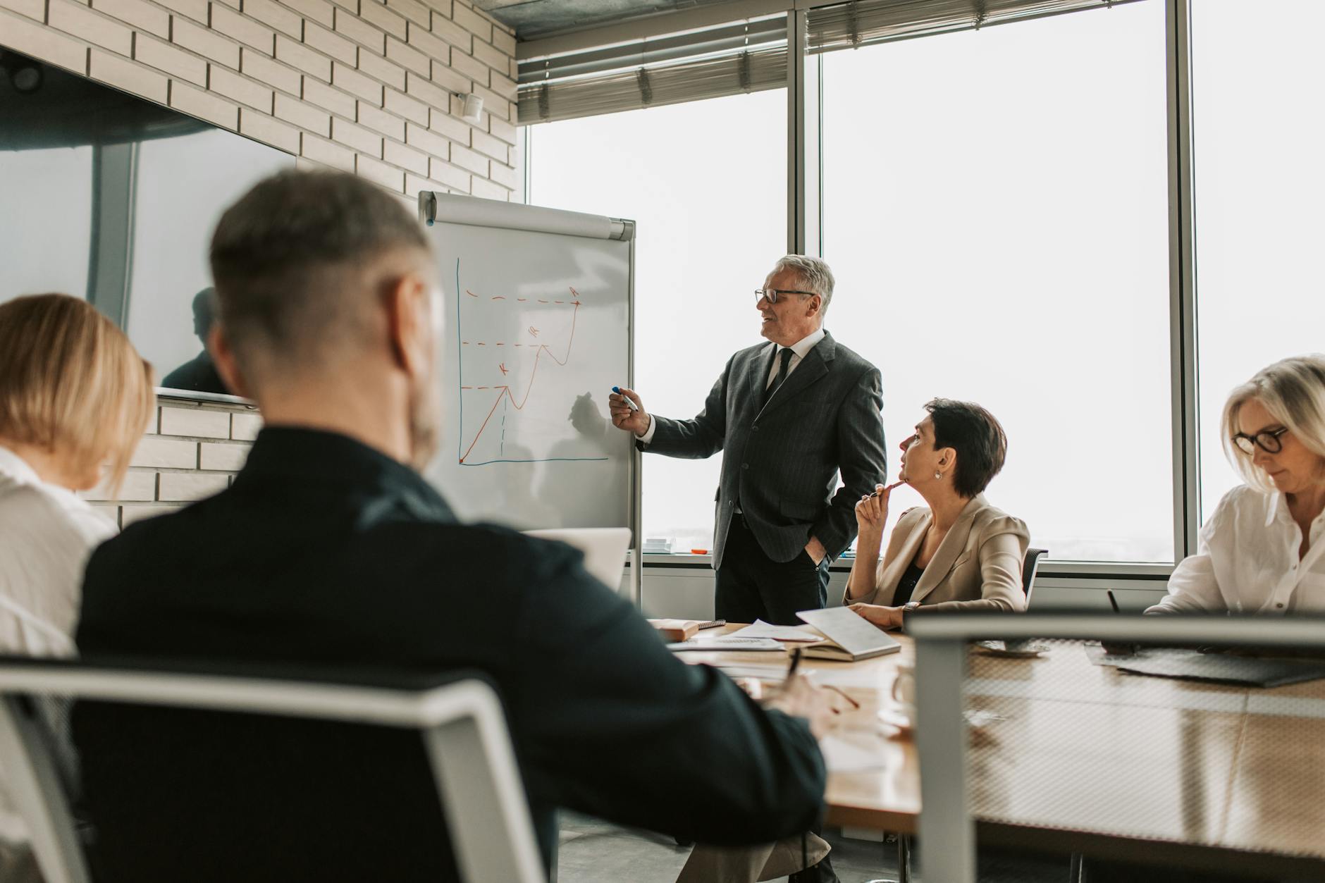 Executives in a boardroom discussing software and operational strategy