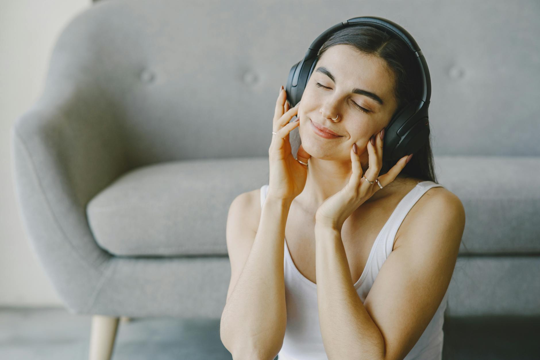 Woman wearing headphones while listening to audio content