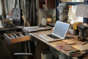 Notion’s New Sites Feature Is Squeezing Webflow’s Smaller Clients Person working on a laptop at a clean desk workspace representing productivity software use