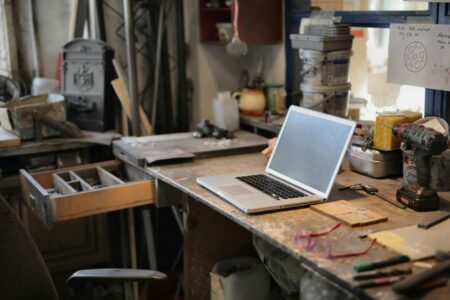 Notion’s New Sites Feature Is Squeezing Webflow’s Smaller Clients Person working on a laptop at a clean desk workspace representing productivity software use