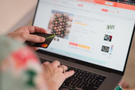 Perplexity’s AI Shopping Feature Is Undercutting Google’s Ad Business Person browsing and shopping online using a laptop computer
