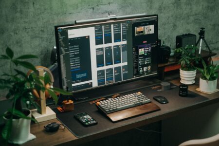 Airtable’s New AI Features Aren’t Slowing Notion’s Momentum A modern workspace with a laptop and productivity tools representing no-code software competition