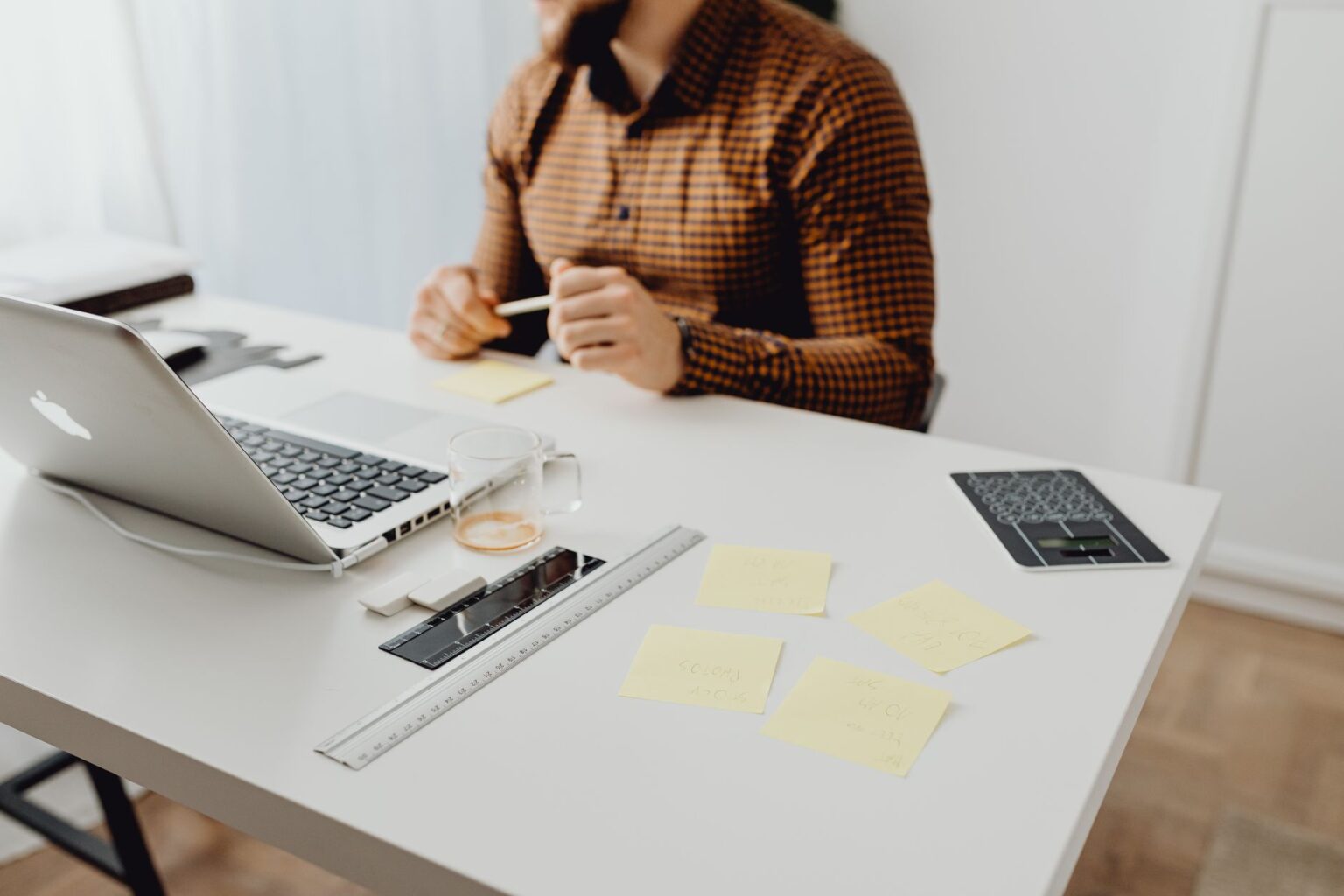 A clean office desk setup with a laptop open to a document workspace