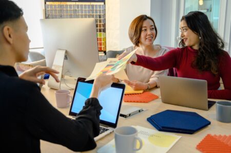 Figma’s Dev Mode Upgrades Are Threatening Zeplin’s Remaining Clients Designers and developers collaborating around a screen during a product handoff meeting