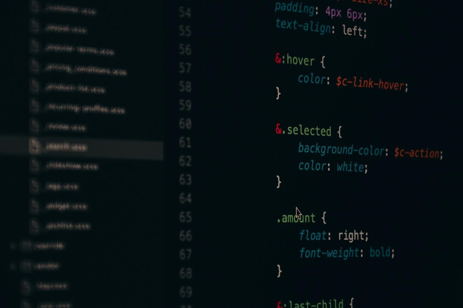 Developer working with a code editor on a desktop monitor
