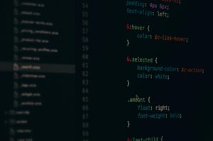 Developer working with a code editor on a desktop monitor