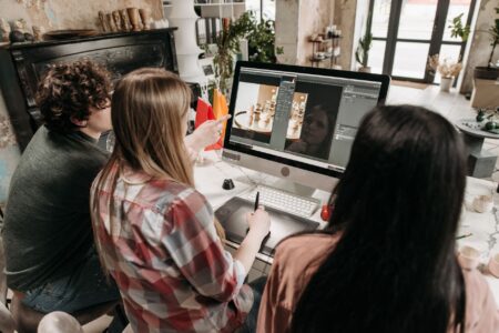Typeface’s Enterprise AI Push Is Circling Adobe’s Creative Cloud Contracts Creative team collaborating on digital content in a modern office environment