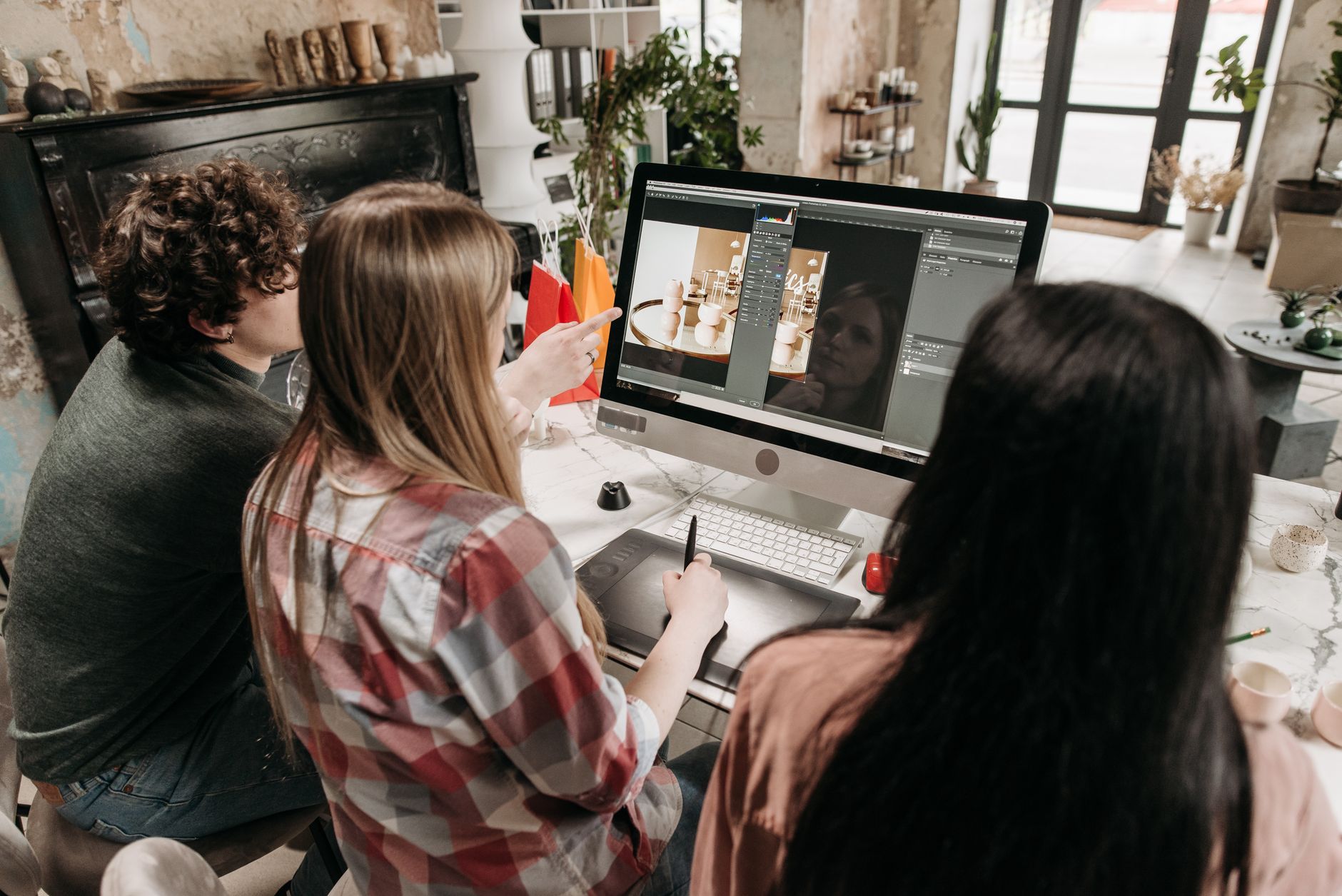 Creative team collaborating on digital content in a modern office environment