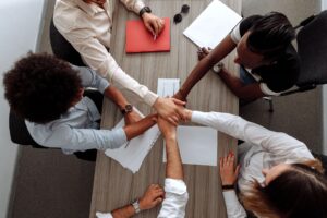 Notion’s Growing Feature Set Is Quietly Threatening Atlassian’s Confluence Team members collaborating on documents at a shared office workspace