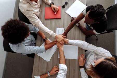 Notion’s Growing Feature Set Is Quietly Threatening Atlassian’s Confluence Team members collaborating on documents at a shared office workspace