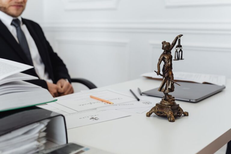 Attorney reviewing legal documents at a desk, representing small law firm research workflow