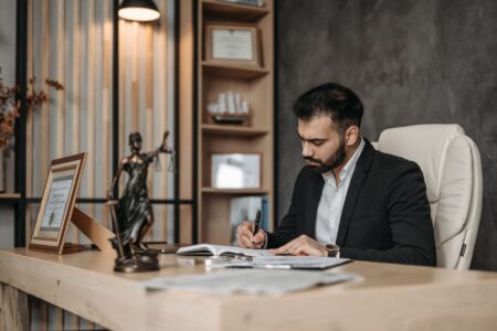 Harvey’s AI Legal Platform Is Squeezing Axiom’s Associate Pipeline Stack of legal documents on a professional desk representing contract review work