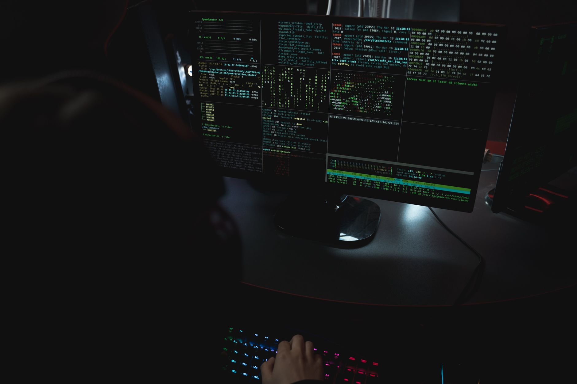 A developer working at a computer with a terminal window open on screen