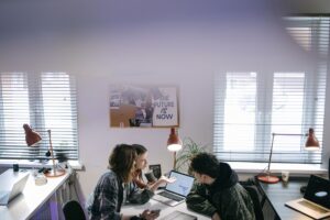 Dust’s Enterprise AI Platform Is Peeling Clients from Microsoft Copilot Enterprise team collaborating around a laptop in a modern office setting